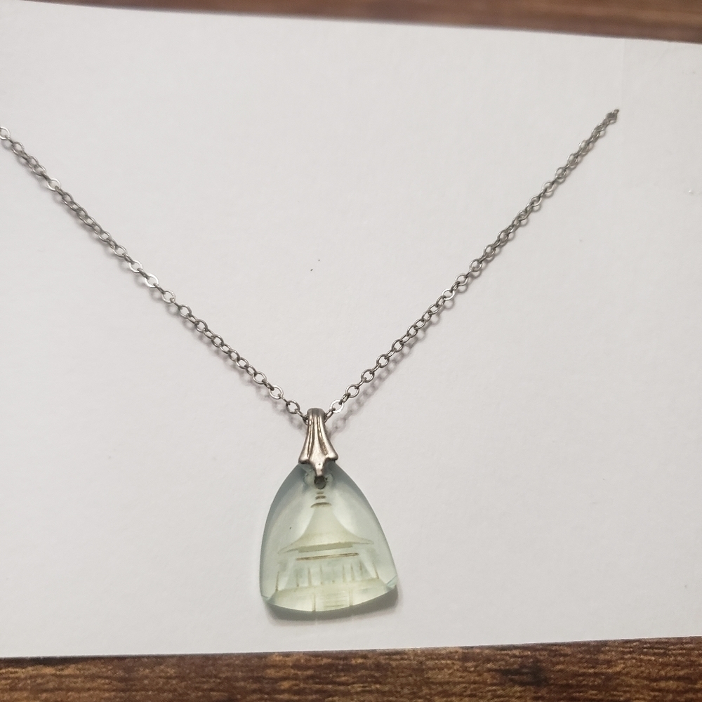 silver tone necklace with etched building on pendant